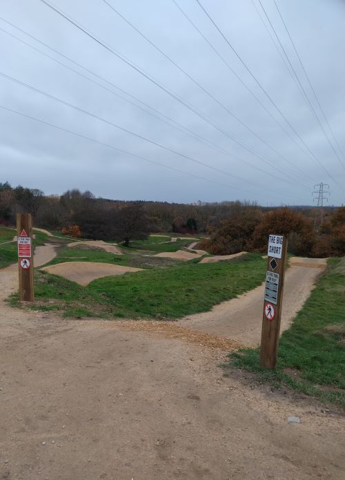 Downward mountain bike trail at Sandwell Urban Bike Park with sign at the top saying The Big Short.