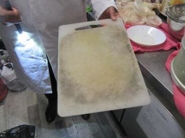 Dirty chopping board being used to prepare food