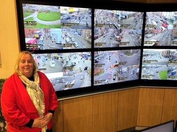 Councillor Hartwell in CCTV room with 6 screens