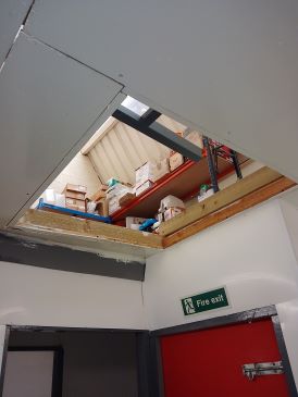 Storage area above mezzanine flooring