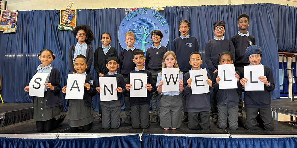 School Children holding up words on paper to spell out Sandwell