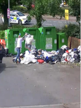 General waste dumped in front of recycling bins