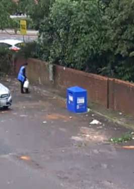 Gas bottle being unloaded from car