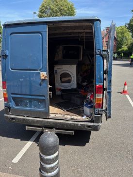Rear view of transit van containing scrap goods